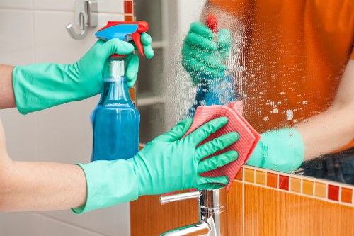 Technician pre-treating carpet stains in a Highbury home